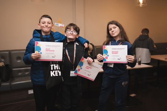 Three Laurel United group members with their certificates at the showcase event