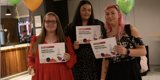 2024 award day vibes, people holding certificates with balloons in the background