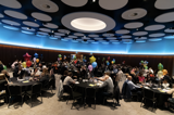 A panoramic view of the award ceremony where everyone is sat at their tables 