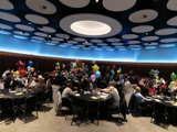 A panoramic view of the award ceremony where everyone is sat at their tables 