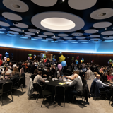 A panoramic view of the award ceremony where everyone is sat at their tables 
