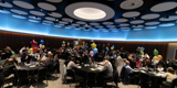 A panoramic view of the award ceremony where everyone is sat at their tables 