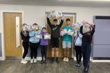 Group holding up the mental health packs they created