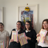 The group posing with their booklets