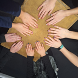 Youth group having a manicure - their hands are looking lovely round the table