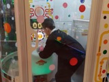 One of the young people playing on the ball grabber game