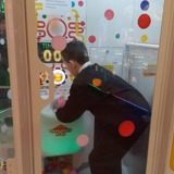 One of the young people playing on the ball grabber game