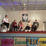 The group onstage, in character