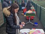 The fundraiser taking part at the side of the football pitch 