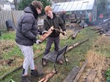Two people from the group in the allotment burning wood 