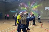 Roller disco in full swing with young people skating around the hall 