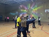 Roller disco in full swing with young people skating around the hall 