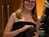 Erin proudly holding an award from The Key Awards 2024