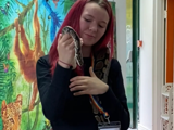 Young person holding a snake